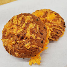 Load image into Gallery viewer, close up of round buns topped with cheese and bacon

