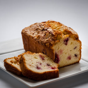 Slices of cherry almond bread on a white plate.