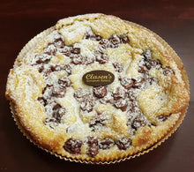 Load image into Gallery viewer, Cherry frangipane tart topped with cherries, powdered sugar and the Clasen chocolate disk
