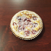 Load image into Gallery viewer, Cherry frangipane tart topped with cherries, and powdered sugar 

